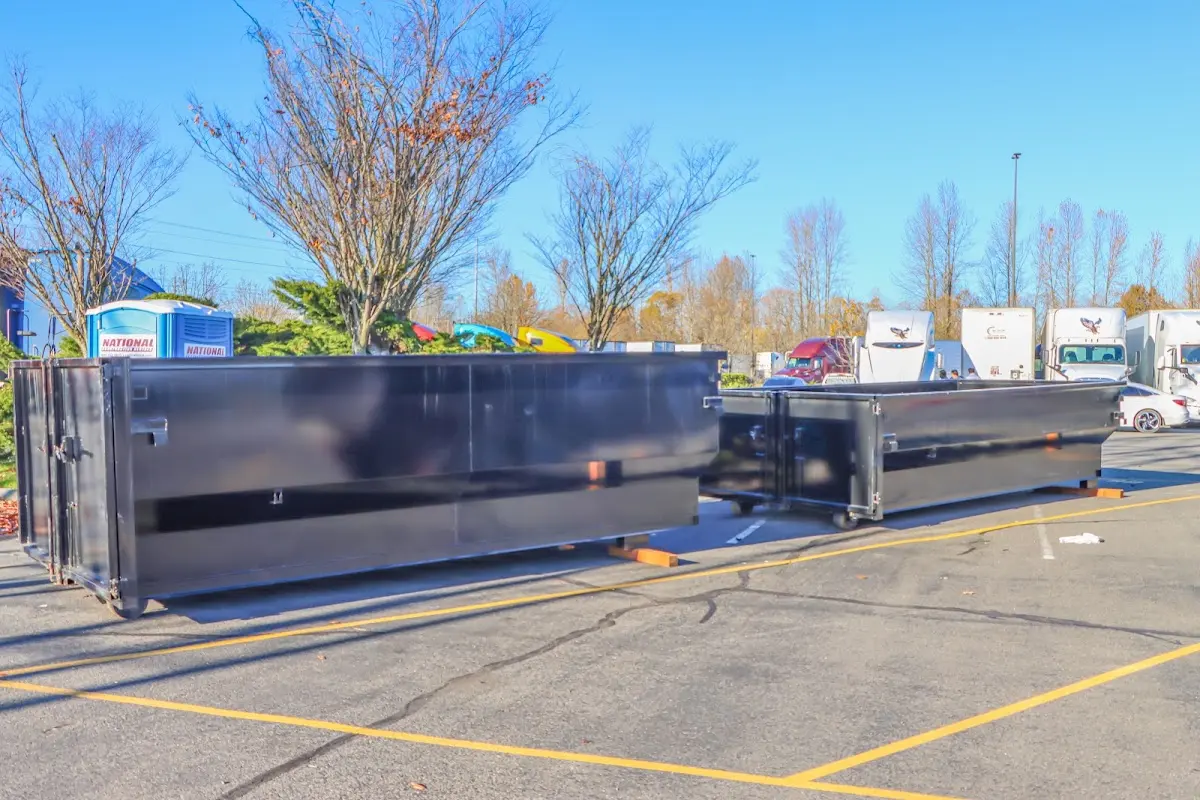 Professional dumpster rental service with roll-off container on residential driveway in Westgate